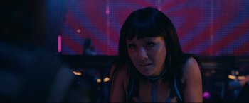 Movie still from “Hustlers” (2019), directed by Lorene Scafaria – A woman with long black hair wearing a blue bra; Close Up shot, Over the shoulder angle