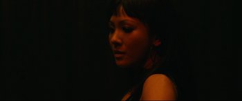 Movie still from “Hustlers” (2019), directed by Lorene Scafaria – A beautiful young woman with a black background; Close Up shot, Low angle