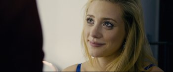 Movie still from “Hustlers” (2019), directed by Lorene Scafaria – A woman's face with blue eye makeup; Close Up shot, Over the shoulder angle