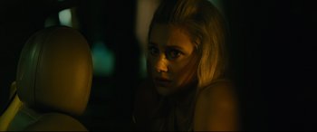 Movie still from “Hustlers” (2019), directed by Lorene Scafaria – A woman with blond hair is looking at the camera; Close Up shot, Over the shoulder angle