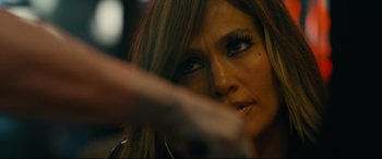 Movie still from “Hustlers” (2019), directed by Lorene Scafaria – A woman's face as she holds a gun; Close Up shot, Over the shoulder angle