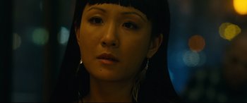 A person wearing a necklace and earrings