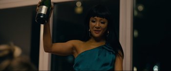Movie still from “Hustlers” (2019), directed by Lorene Scafaria – A woman in a blue dress holding her arm up; Close Up shot, Low angle