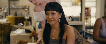Movie still from “Hustlers” (2019), directed by Lorene Scafaria – A woman with long black hair wearing a necklace and earrings; Close Up shot, Over the shoulder angle