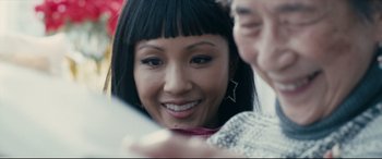 Movie still from “Hustlers” (2019), directed by Lorene Scafaria – A woman looking at a cell phone with another woman looking on; Close Up shot, Over the shoulder angle