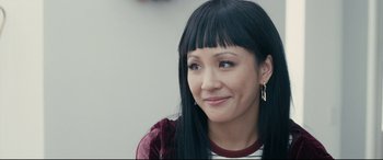 Movie still from “Hustlers” (2019), directed by Lorene Scafaria – A person with long black hair; Close Up shot, Over the shoulder angle