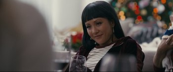 Movie still from “Hustlers” (2019), directed by Lorene Scafaria – A person sitting at a table with a glass of wine; Close Up shot, Over the shoulder angle