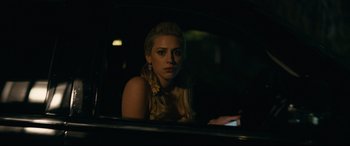 Movie still from “Hustlers” (2019), directed by Lorene Scafaria – A woman sitting in the back of a car at night; Close Up shot, Over the shoulder angle