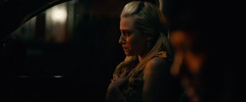 Movie still from “Hustlers” (2019), directed by Lorene Scafaria – A woman with blonde long hair is looking to the side; Close Up shot, Over the shoulder angle