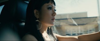 Movie still from “Hustlers” (2019), directed by Lorene Scafaria – A woman with long black hair wearing a black top; Close Up shot, Low angle