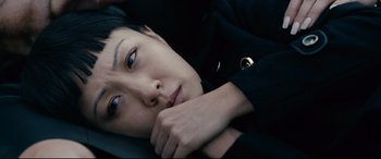 Movie still from “Hustlers” (2019), directed by Lorene Scafaria – A woman laying down with her head resting on her hand; Close Up shot, Overhead angle