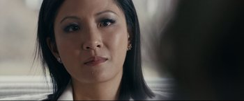 Movie still from “Hustlers” (2019), directed by Lorene Scafaria – A woman's face in a white shirt; Close Up shot, Over the shoulder angle