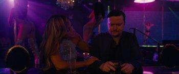 Movie still from “Hustlers” (2019), directed by Lorene Scafaria – A man and a woman sitting at a bar; Medium shot, Over the shoulder angle