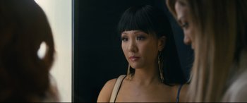 Movie still from “Hustlers” (2019), directed by Lorene Scafaria – A young woman with bangs looking into a mirror; Close Up shot, Over the shoulder angle
