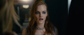 Movie still from “Hustlers” (2019), directed by Lorene Scafaria – A person wearing a necklace; Close Up shot, Over the shoulder angle