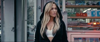 Movie still from “Hustlers” (2019), directed by Lorene Scafaria – A woman with long blonde hair wearing a black hoodie; Close Up shot, Over the shoulder angle