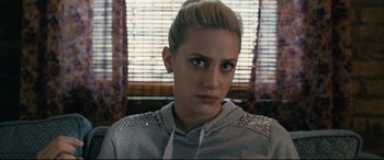 Movie still from “Hustlers” (2019), directed by Lorene Scafaria – A person wearing a hoodie; Close Up shot, Over the shoulder angle