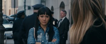Movie still from “Hustlers” (2019), directed by Lorene Scafaria – A woman standing in front of a group of people; Close Up shot, Over the shoulder angle