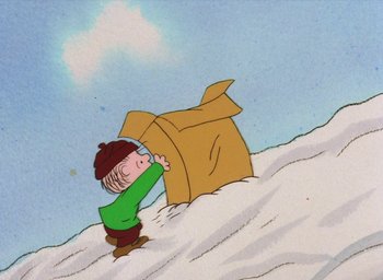 Movie still from “It's Christmastime Again, Charlie Brown” (1992), directed by Bill Melendez – A charlie brown character is pulling something out of the snow; Extreme Wide shot, High angle