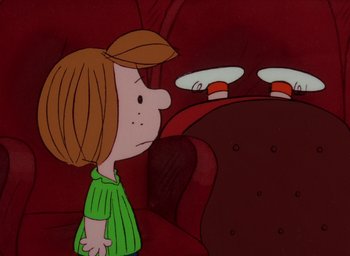Movie still from “It's Christmastime Again, Charlie Brown” (1992), directed by Bill Melendez – A cartoon of a girl standing next to a couch; Extreme Wide shot, High angle