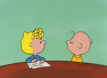 Movie still from “It's Christmastime Again, Charlie Brown” (1992), directed by Bill Melendez – A drawing of a boy and a girl sitting at a table; Medium shot, High angle