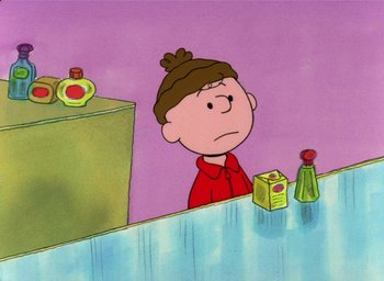 Movie still from “It's Christmastime Again, Charlie Brown” (1992), directed by Bill Melendez – Charlie brown sitting at a table in front of a refrigerator; Medium shot, High angle