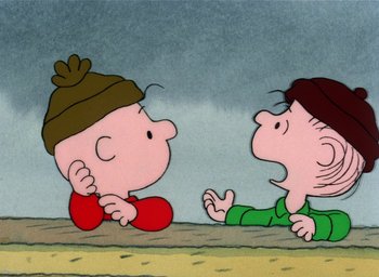 Movie still from “It's Christmastime Again, Charlie Brown” (1992), directed by Bill Melendez – A couple of people that are sitting on the ground together; Medium shot, High angle