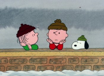 Movie still from “It's Christmastime Again, Charlie Brown” (1992), directed by Bill Melendez – A group of cartoon characters sitting on top of a brick wall; Extreme Wide shot, High angle