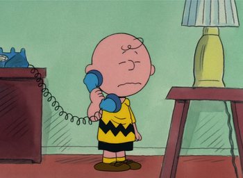 Movie still from “It's Christmastime Again, Charlie Brown” (1992), directed by Bill Melendez – A charlie brown cartoon character holding a phone to his ear; Medium shot, High angle