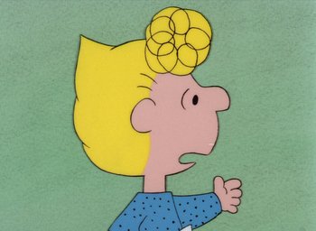 Movie still from “It's Christmastime Again, Charlie Brown” (1992), directed by Bill Melendez – A drawing of a blond boy with a yellow hairpiece; Close Up shot, High angle