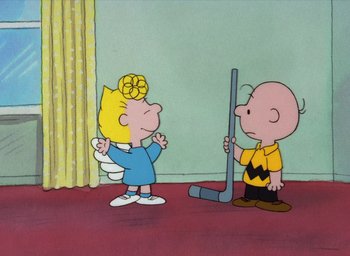 Movie still from “It's Christmastime Again, Charlie Brown” (1992), directed by Bill Melendez – A charlie brown and a blond girl are playing hockey together; Extreme Wide shot, High angle