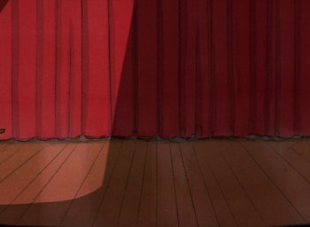 Movie still from “It's Christmastime Again, Charlie Brown” (1992), directed by Bill Melendez – A red stage with a wooden floor and a red curtain; Extreme Wide shot, Low angle