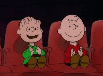 Movie still from “It's Christmastime Again, Charlie Brown” (1992), directed by Bill Melendez – A couple of people that are sitting in a chair; Medium shot, High angle