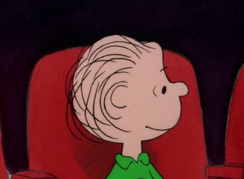 Movie still from “It's Christmastime Again, Charlie Brown” (1992), directed by Bill Melendez – A charlie brown character sitting in a chair; Close Up shot, High angle