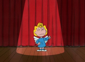 Movie still from “It's Christmastime Again, Charlie Brown” (1992), directed by Bill Melendez – A cartoon of a girl in a blue dress with wings; Wide shot, Low angle