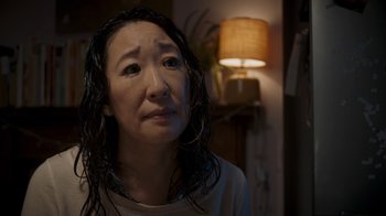 Movie still from “Killing Eve” (2018), created by Phoebe Waller-Bridge – An asian woman with wet hair looking sad; Close Up shot, Over the shoulder angle