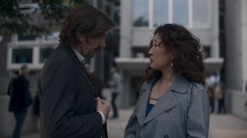 Movie still from “Killing Eve” (2018), created by Phoebe Waller-Bridge – A man and a woman talking to each other outside; Medium shot, Over the shoulder angle