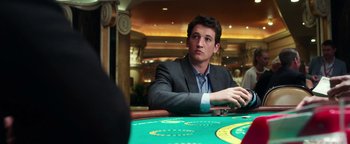 Movie still from “War Dogs” (2016), directed by Todd Phillips – A man sitting at a table in front of cards; Close Up shot, Over the shoulder angle