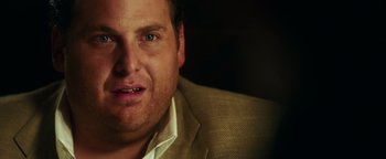 Movie still from “War Dogs” (2016), directed by Todd Phillips – A person wearing a suit; Close Up shot, Over the shoulder angle