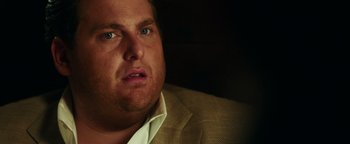 Movie still from “War Dogs” (2016), directed by Todd Phillips – A person wearing a suit; Close Up shot, Over the shoulder angle