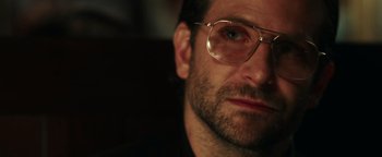Movie still from “War Dogs” (2016), directed by Todd Phillips – A person wearing glasses; Close Up shot, Over the shoulder angle