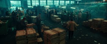 Movie still from “War Dogs” (2016), directed by Todd Phillips – A room filled with lots of boxes and people working; Wide shot, High angle