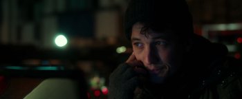 Movie still from “War Dogs” (2016), directed by Todd Phillips – A man in a hat and gloves is looking at the camera; Close Up shot, Over the shoulder angle