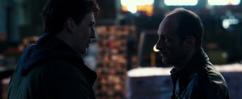 Movie still from “War Dogs” (2016), directed by Todd Phillips – Two men are facing each other in a dark room; Close Up shot, Over the shoulder angle