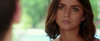 Movie still from “War Dogs” (2016), directed by Todd Phillips – A woman's face with brown hair and green eyes; Close Up shot, Over the shoulder angle
