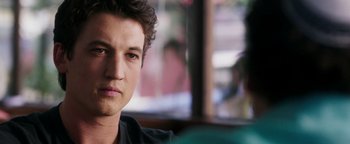 Movie still from “War Dogs” (2016), directed by Todd Phillips – A young man's face in front of a window; Close Up shot, Over the shoulder angle