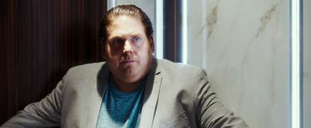 Movie still from “War Dogs” (2016), directed by Todd Phillips – A person wearing a jacket; Close Up shot, Over the shoulder angle