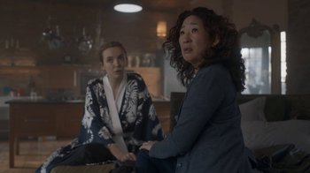 Movie still from “Killing Eve” (2018), created by Phoebe Waller-Bridge – Two women sitting in a room next to each other; Medium shot, Over the shoulder angle