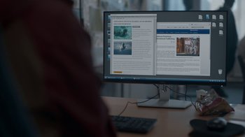 Movie still from “Killing Eve” (2018), created by Phoebe Waller-Bridge – A computer monitor and a keyboard on a desk; Extreme Close Up shot, Over the shoulder angle