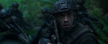 Movie still from “War for the Planet of the Apes” (2017), directed by Matt Reeves – A man with a helmet on holding a rifle; Close Up shot, Low angle